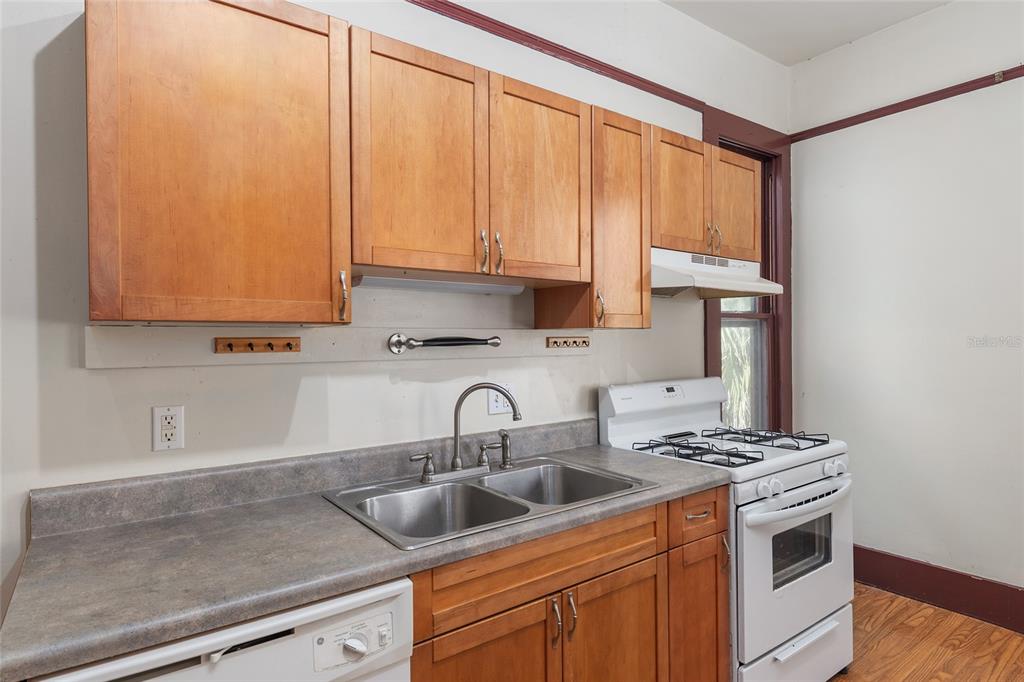 306 Northeast 3rd Street Gainesville, FL 32601 - Photo 25 of 88 a kitchen with stainless steel appliances granite countertop a sink a stove and a microwave