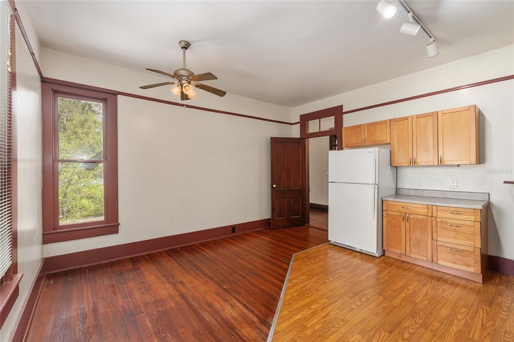 306 Northeast 3rd Street Gainesville, FL 32601 - Photo 26 of 88 a view of empty room with wooden floor and fan
