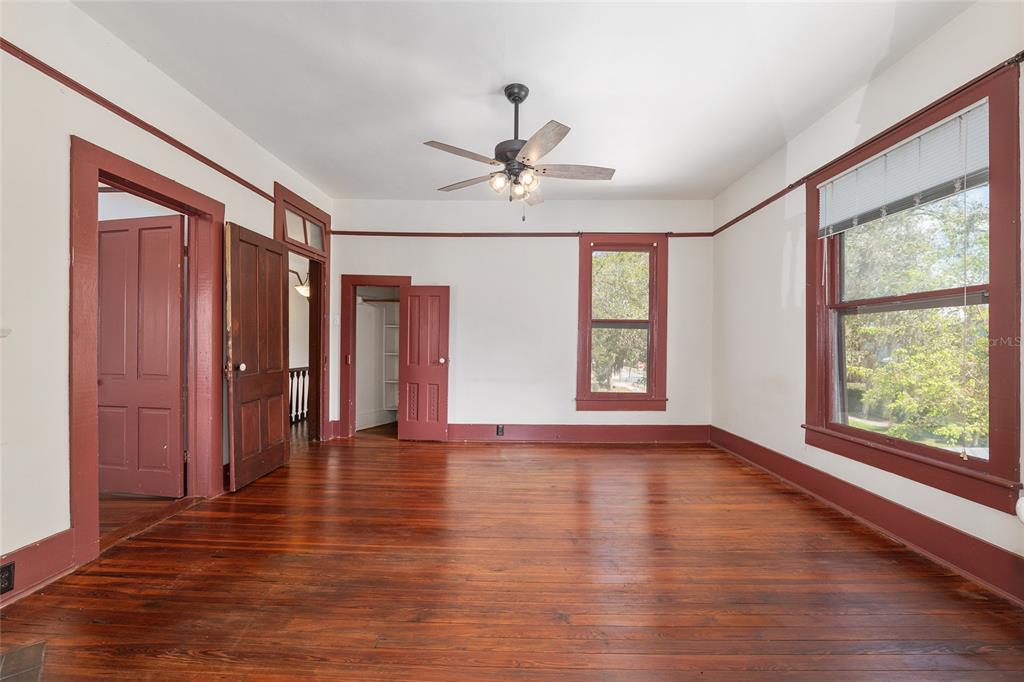 306 Northeast 3rd Street Gainesville, FL 32601 - Photo 32 of 88 a view of an empty room with a window and wooden floor
