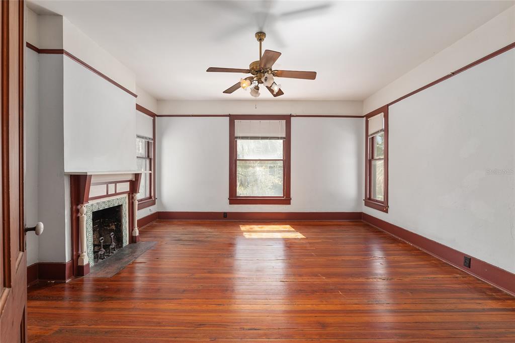 306 Northeast 3rd Street Gainesville, FL 32601 - Photo 33 of 88 a view of an empty room with wooden floor fireplace and a window