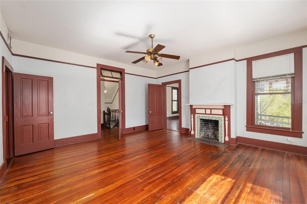 306 Northeast 3rd Street Gainesville, FL 32601 - Photo 34 of 88 a view of an empty room with wooden floor fireplace and a window