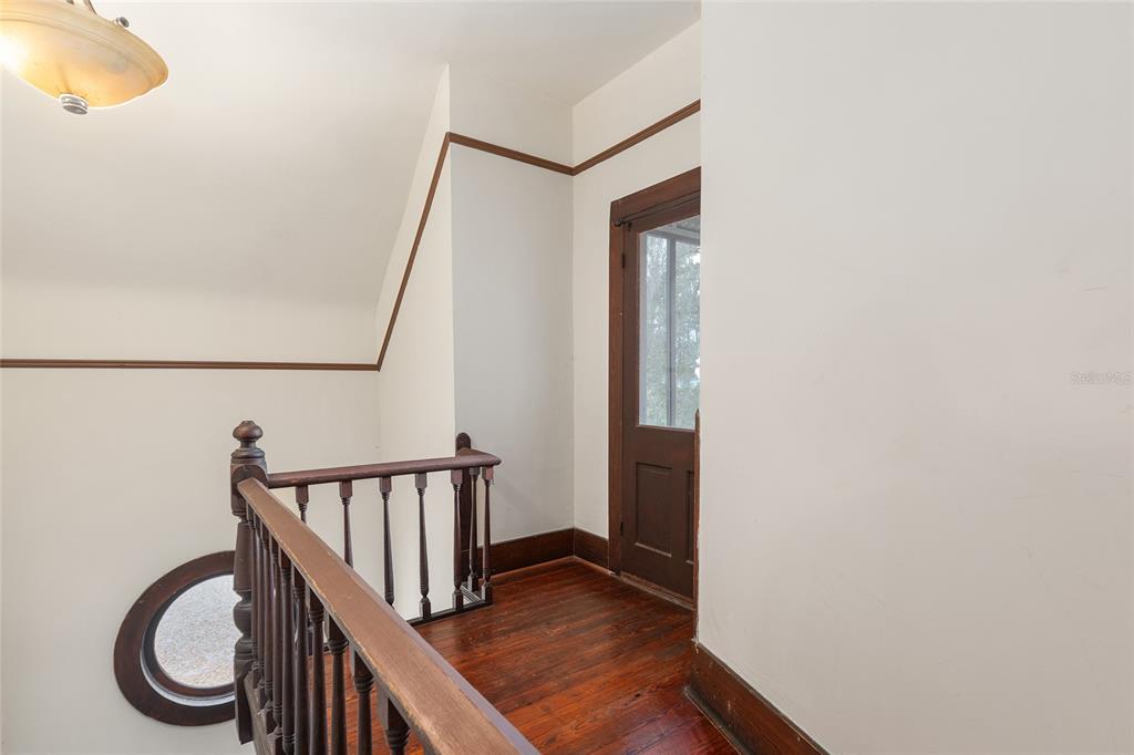 306 Northeast 3rd Street Gainesville, FL 32601 - Photo 36 of 88 a view of a hallway with wooden floor and staircase