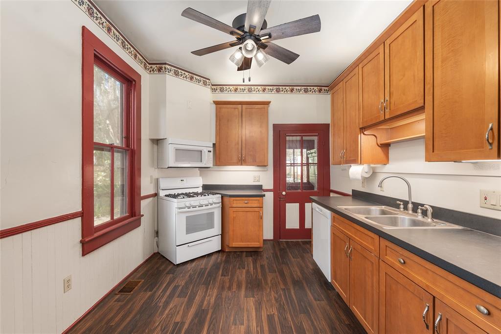 306 Northeast 3rd Street Gainesville, FL 32601 - Photo 47 of 88 a kitchen with stainless steel appliances granite countertop a sink stove and refrigerator
