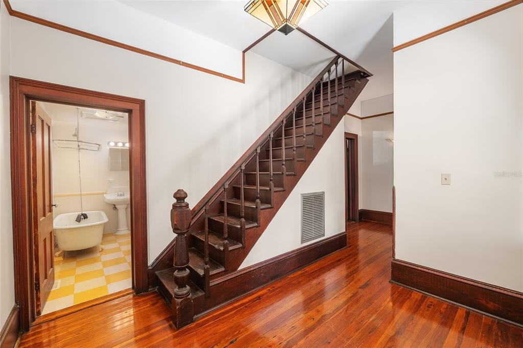 306 Northeast 3rd Street Gainesville, FL 32601 - Photo 55 of 88 a view of a hallway with wooden floor and stairs