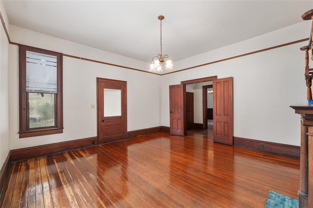 306 Northeast 3rd Street Gainesville, FL 32601 - Photo 58 of 88 a view of an empty room with wooden floor and window