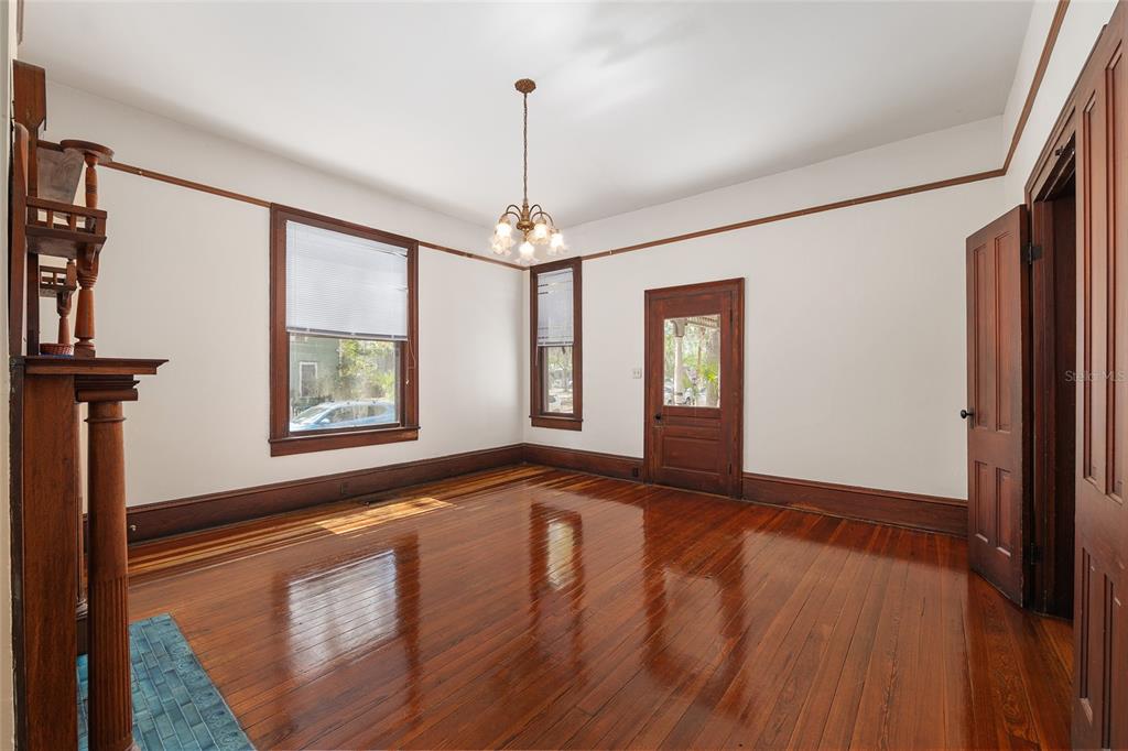 306 Northeast 3rd Street Gainesville, FL 32601 - Photo 61 of 88 a view of an empty room with window and wooden floor