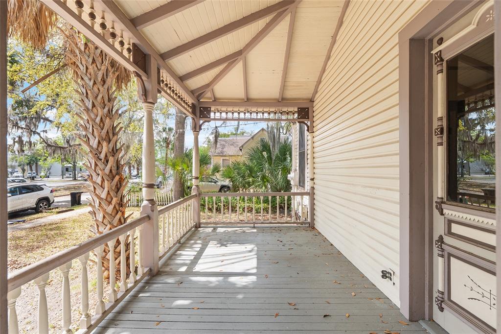 306 Northeast 3rd Street Gainesville, FL 32601 - Photo 62 of 88 a view of a porch with wooden floor and iron stairs