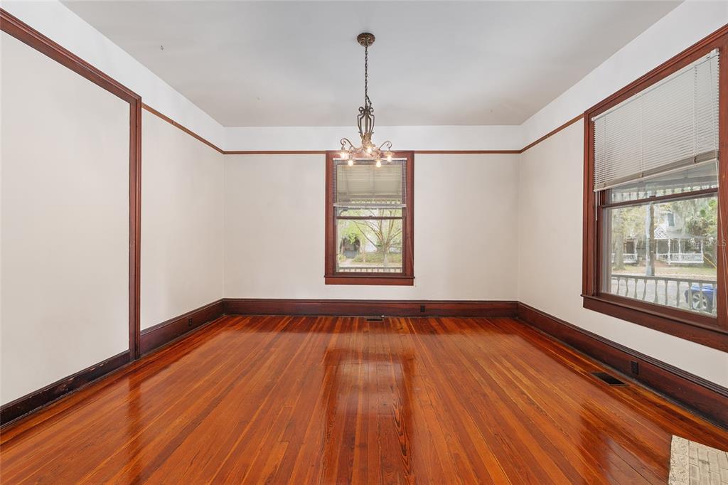 306 Northeast 3rd Street Gainesville, FL 32601 - Photo 64 of 88 a view of an empty room with wooden floor and a window