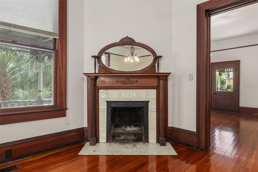 306 Northeast 3rd Street Gainesville, FL 32601 - Photo 67 of 88 a living room with a fireplace and a wooden floor