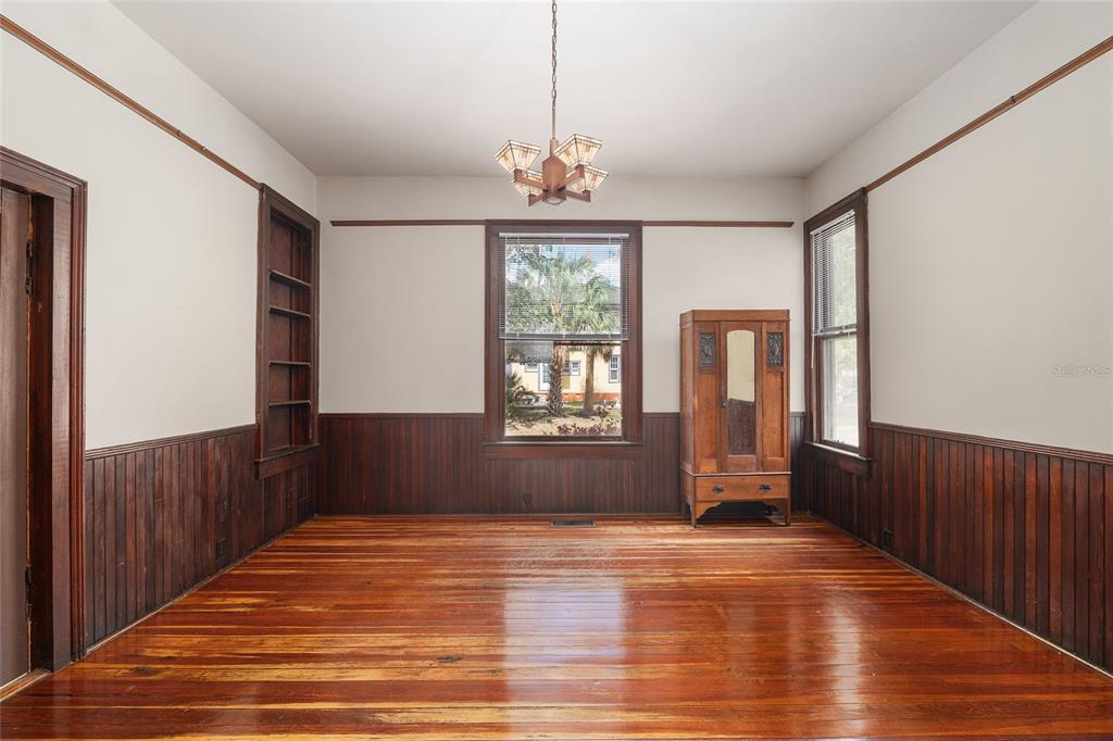 306 Northeast 3rd Street Gainesville, FL 32601 - Photo 71 of 88 a view of an empty room with wooden floor and a window