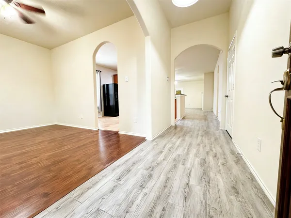 a view of a room with wooden floor and staircase