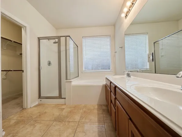 a bathroom with a granite countertop sink and a bathtub
