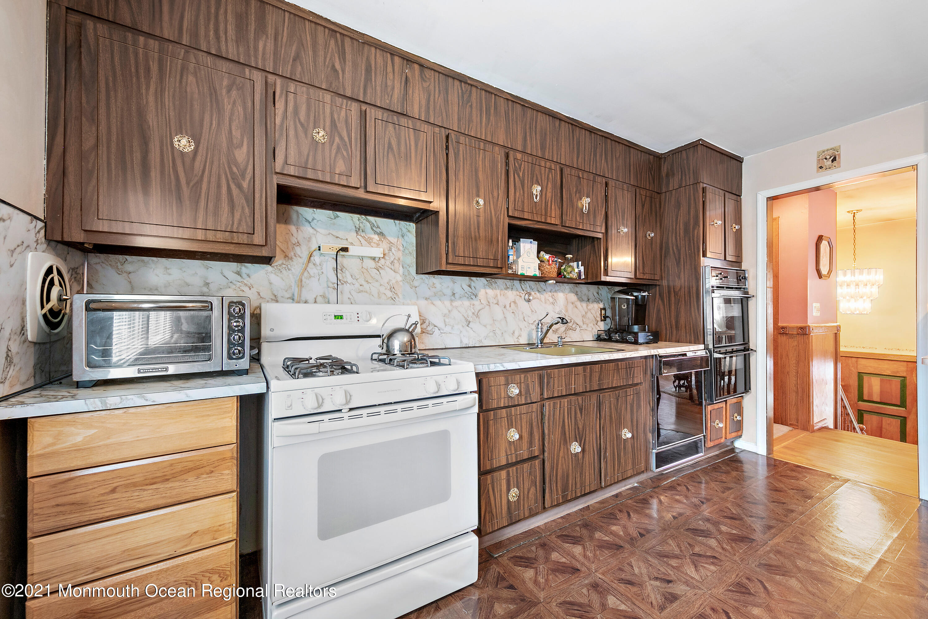 550 South Cooks Bridge Road Jackson, NJ 08527 - Photo 13 of 39 a kitchen with kitchen island granite countertop wooden cabinets and white appliances