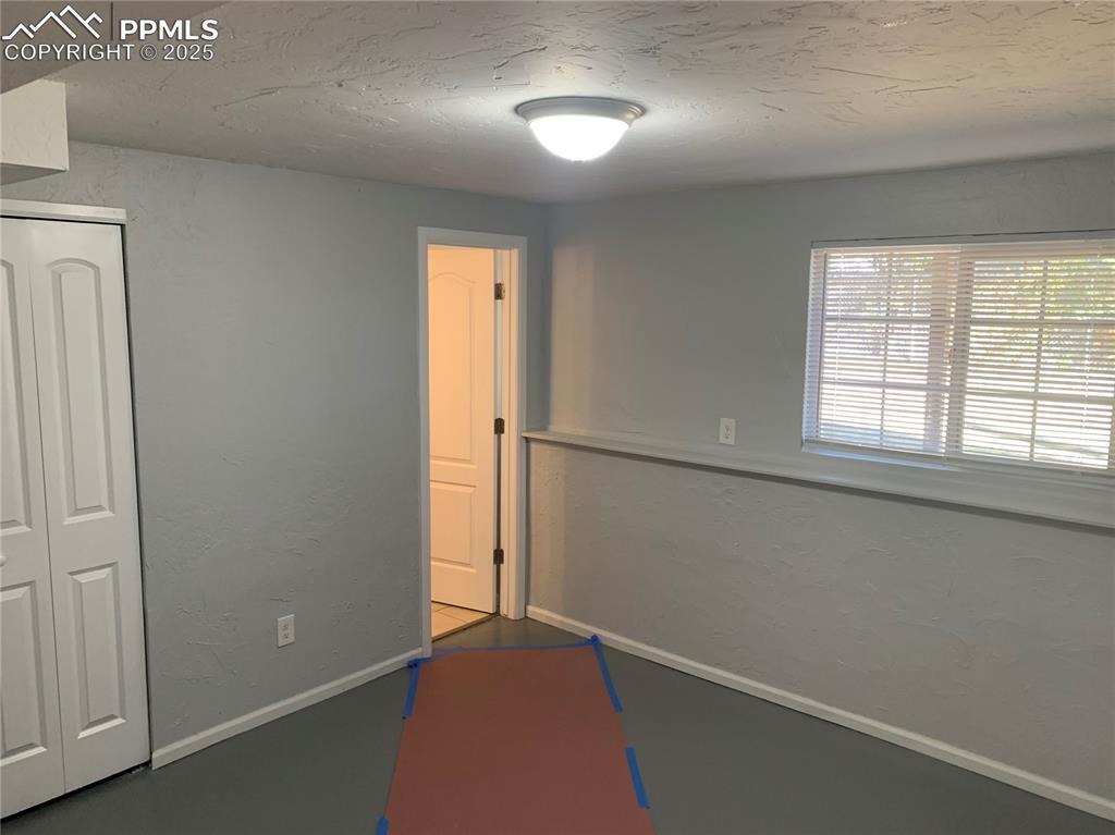 1057 Peterson Road Colorado Springs, CO 80915 - Photo 31 of 32 Game room featuring a textured wall and a textured ceiling