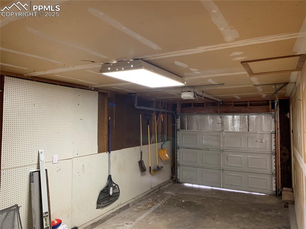 1057 Peterson Road Colorado Springs, CO 80915 - Photo 32 of 32 Garage featuring a garage door opener