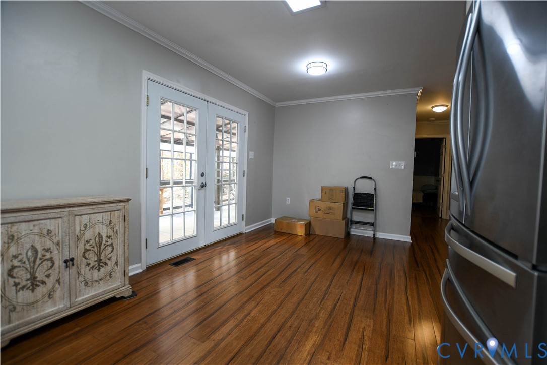 153 Deer Trail Aylett, VA 23009 - Photo 11 of 50 a view of an empty room with wooden floor and a window