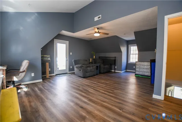 a bedroom with bed and wooden floor