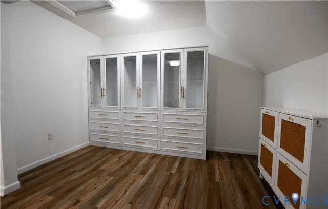 a kitchen with stainless steel appliances granite countertop a refrigerator oven a sink with wooden cabinets and floors