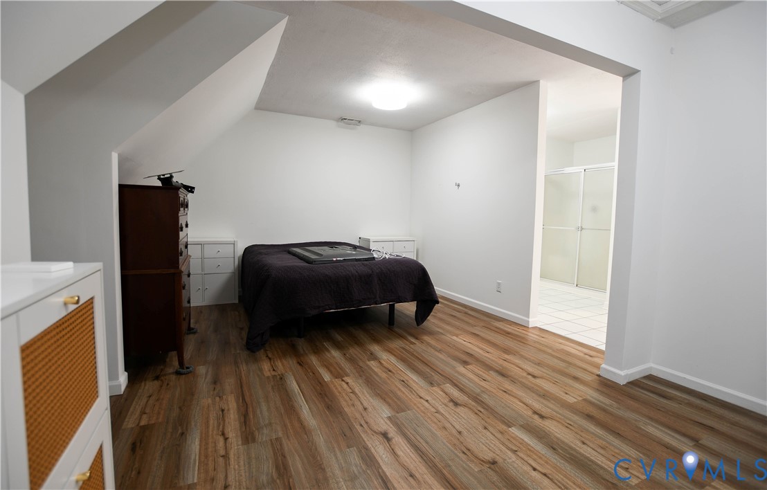 153 Deer Trail Aylett, VA 23009 - Photo 21 of 50 a living room with a bed and a wooden floor
