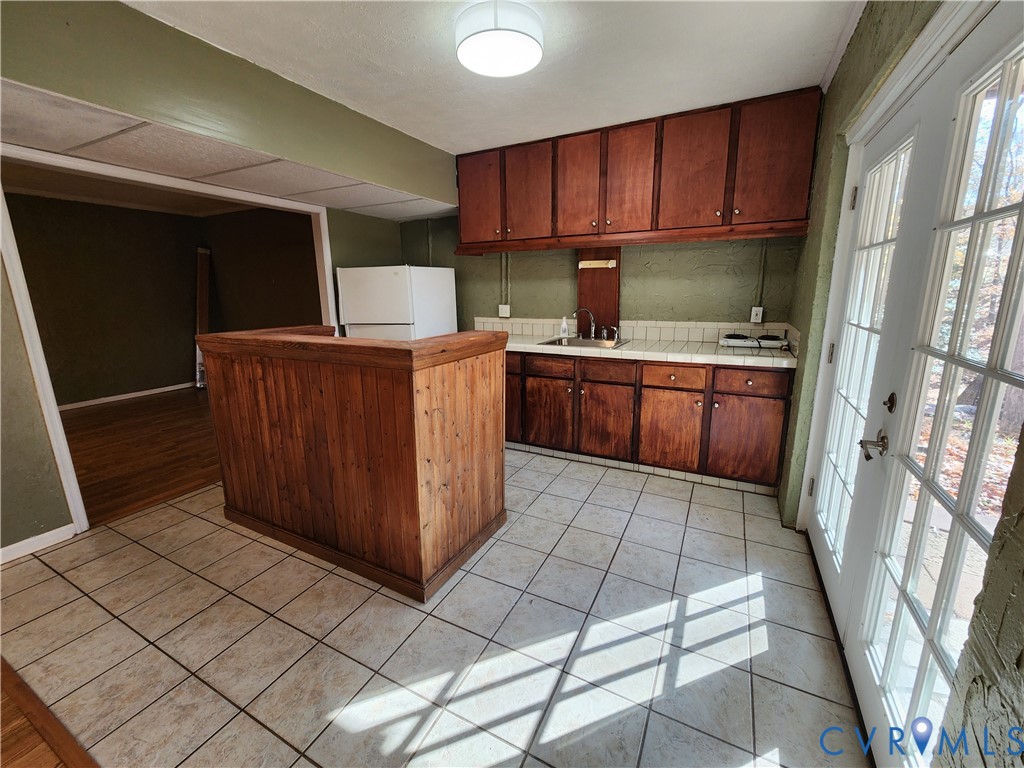 153 Deer Trail Aylett, VA 23009 - Photo 24 of 50 a kitchen with stainless steel appliances granite countertop a refrigerator oven a sink with wooden cabinets and floors