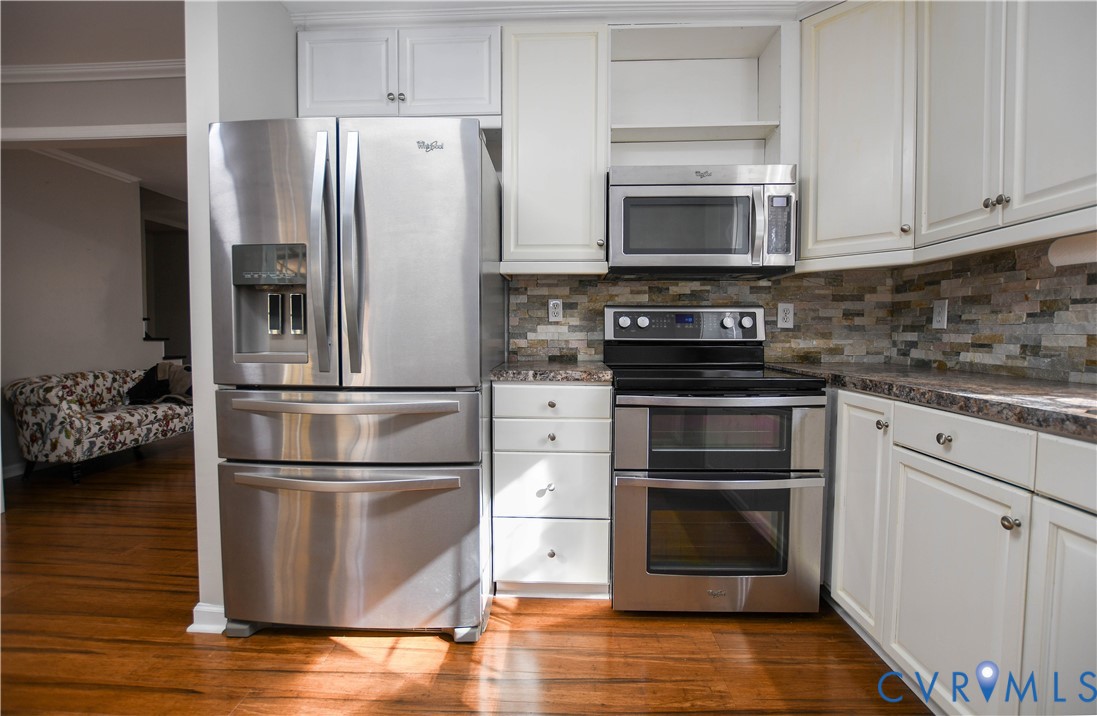 153 Deer Trail Aylett, VA 23009 - Photo 10 of 50 a kitchen with cabinets stainless steel appliances and wooden floor