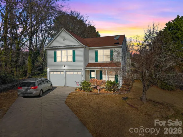 a car parked in front of white house