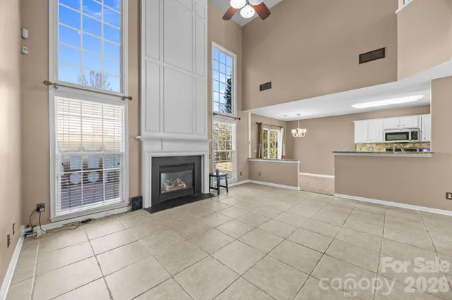 a view of a livingroom with a fireplace and window