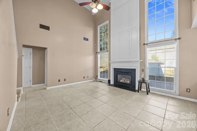 a view of a livingroom with wooden floor and a ceiling fan