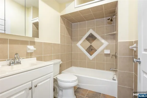 a bathroom with a sink mirror toilet and bathtub