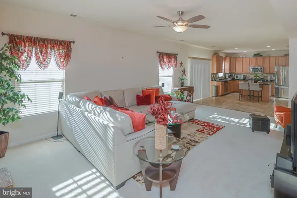 a living room with furniture and kitchen view