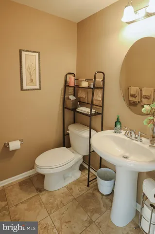 a white toilet sitting next to a bathroom sink