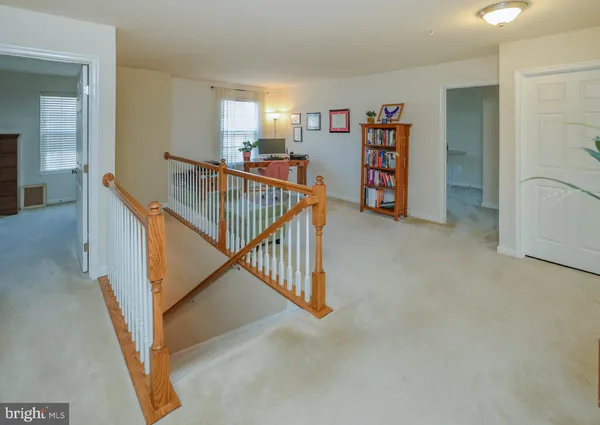 a view of a hallway with seating area