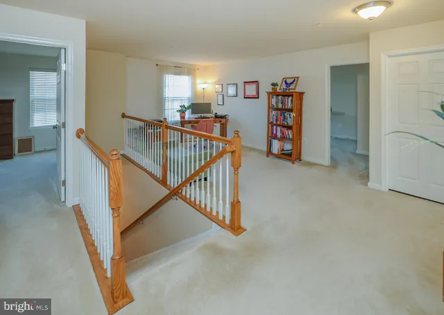 a view of a hallway with seating area