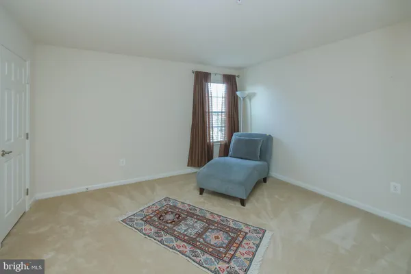 a living room with couch and a rug