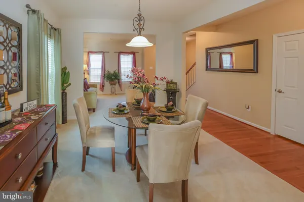 a view of a dining room with furniture and a chandelier
