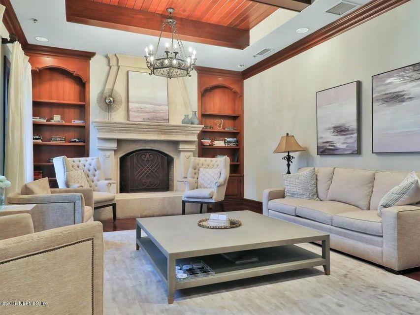 142 Marshall Creek Drive St. Augustine, FL 32095 - Photo 123 of 176 a living room with furniture a chandelier and a fireplace