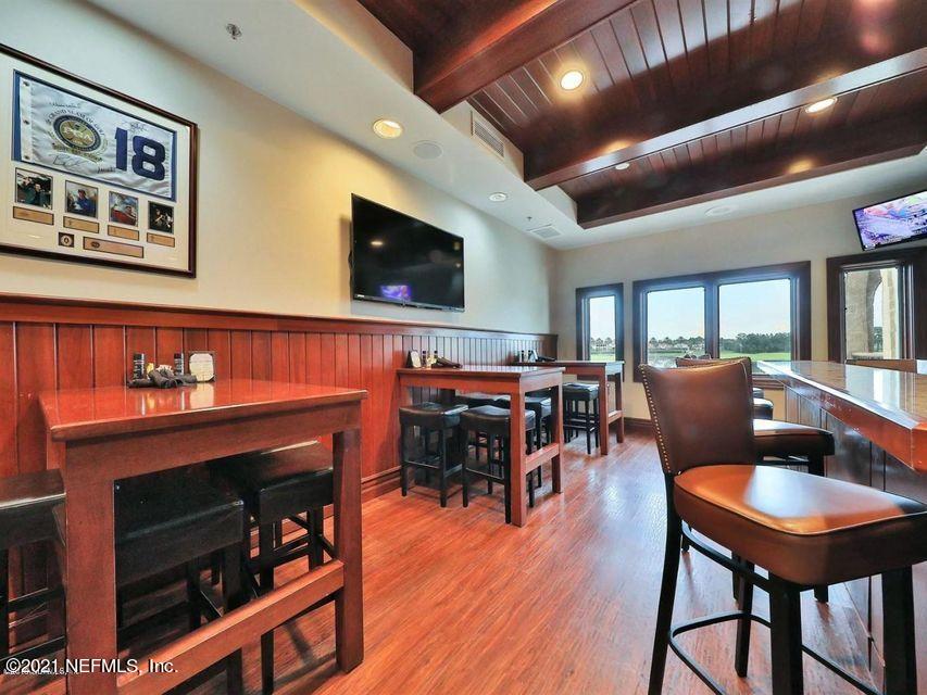 142 Marshall Creek Drive St. Augustine, FL 32095 - Photo 136 of 176 a living room with furniture a flat screen tv and kitchen view