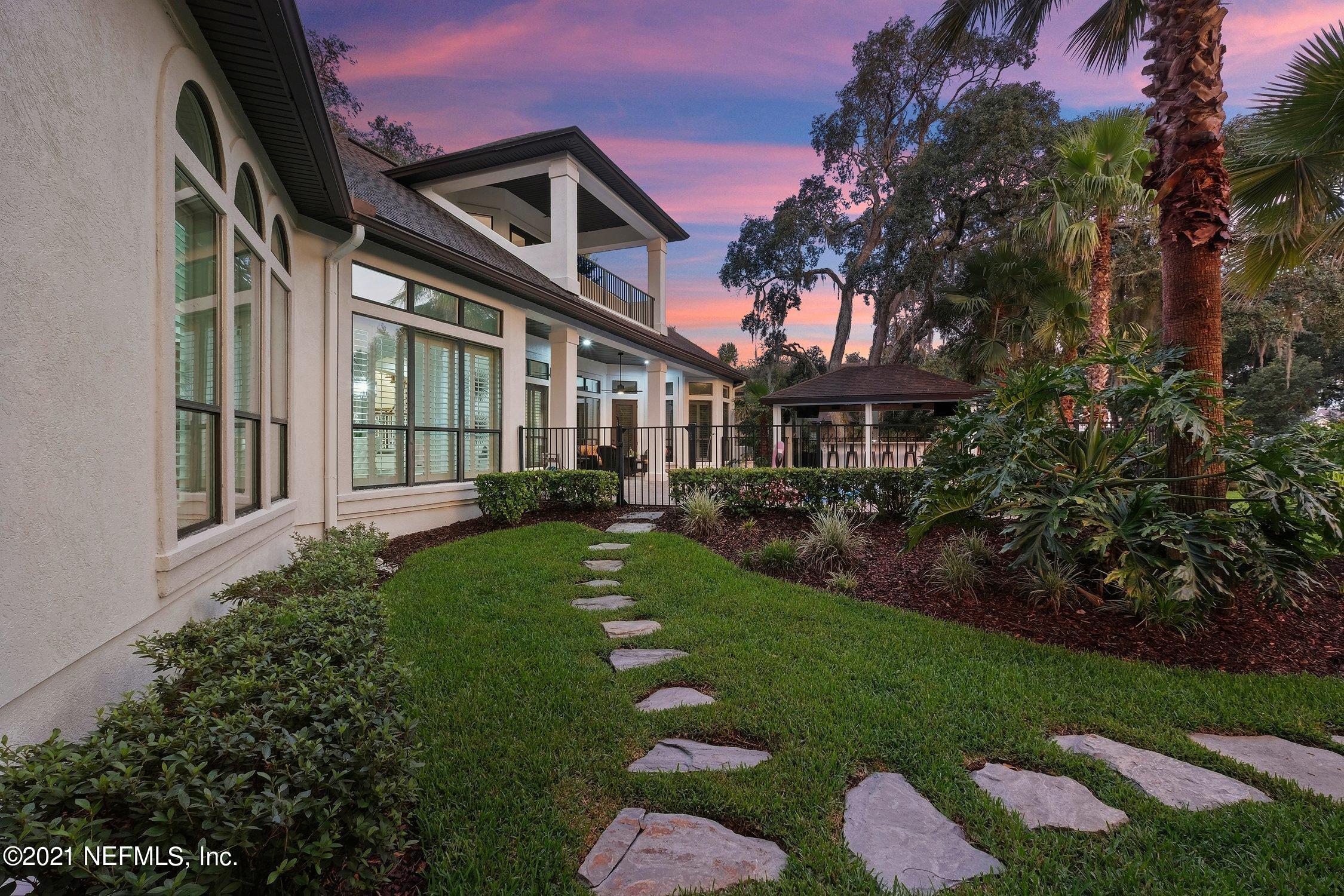 142 Marshall Creek Drive St. Augustine, FL 32095 - Photo 170 of 176 a front view of a house with a yard table and chairs