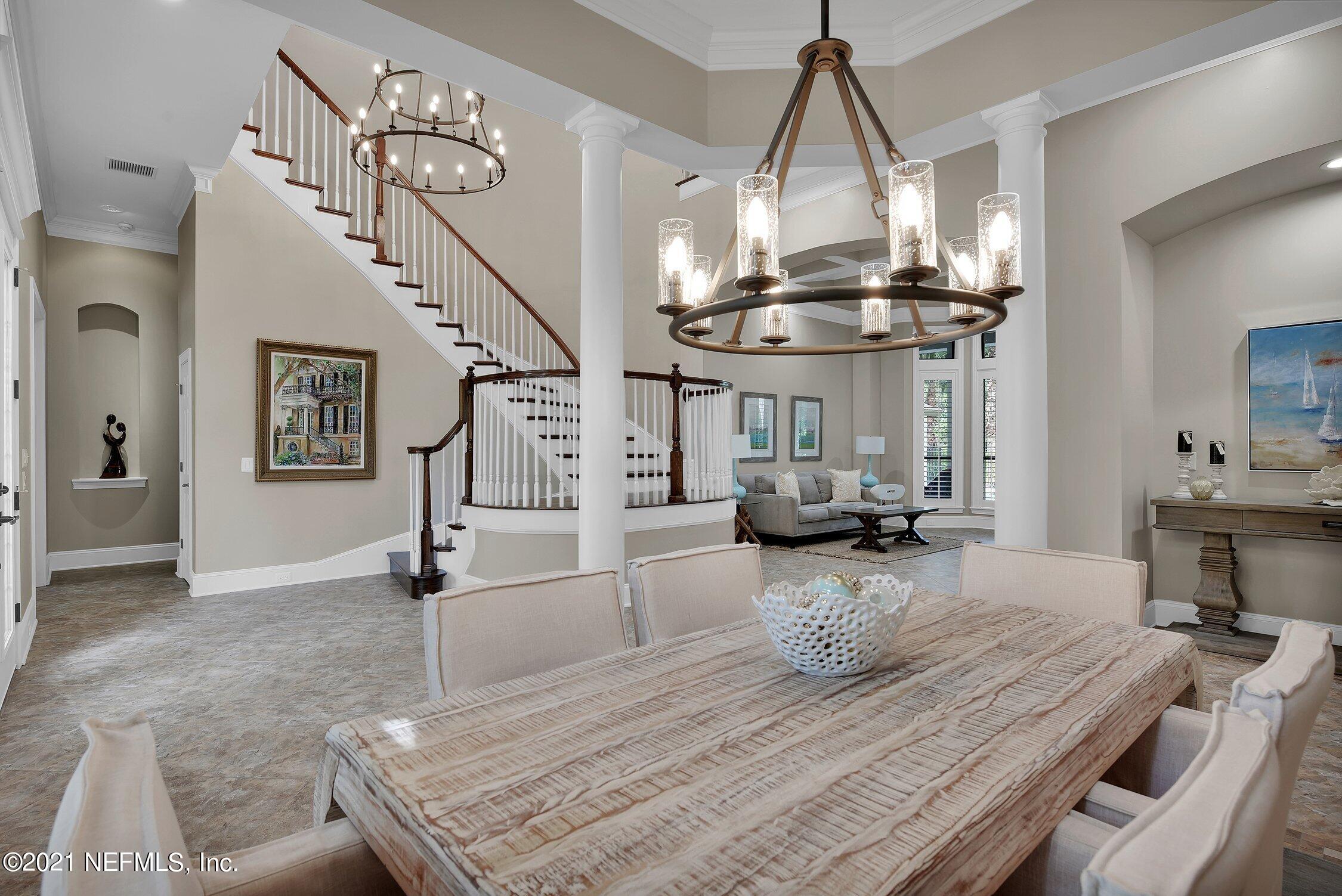142 Marshall Creek Drive St. Augustine, FL 32095 - Photo 21 of 176 a view of a dining room and livingroom with furniture wooden floor a chandelier