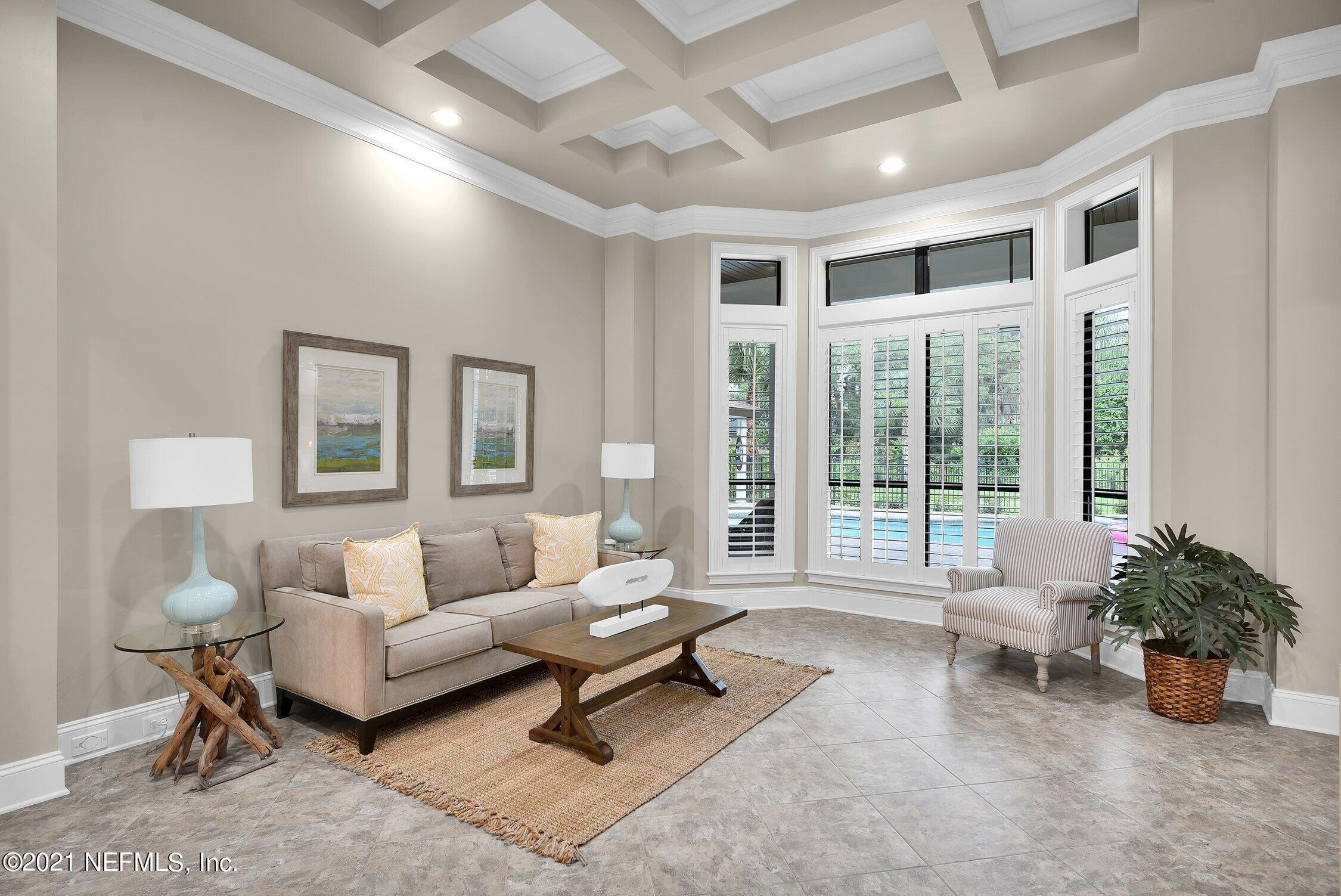 142 Marshall Creek Drive St. Augustine, FL 32095 - Photo 25 of 176 a living room with furniture and floor to ceiling windows