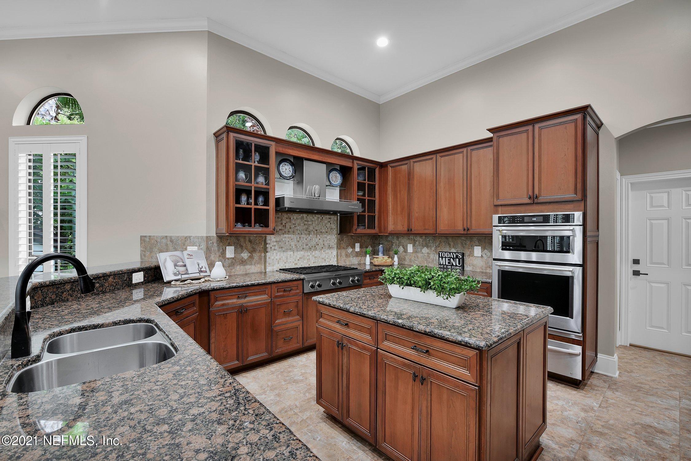 142 Marshall Creek Drive St. Augustine, FL 32095 - Photo 35 of 176 a kitchen with granite countertop a sink and a stove top oven