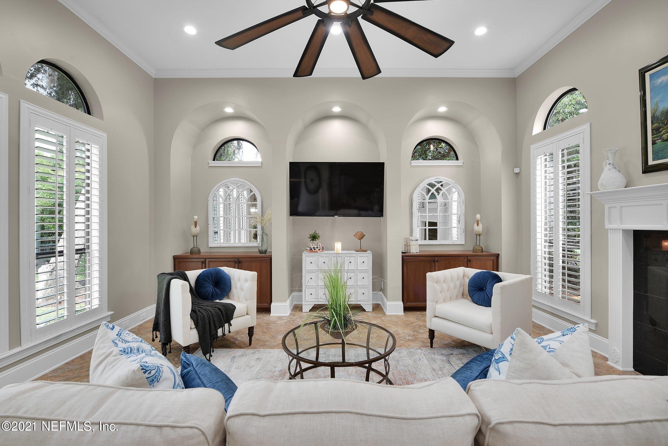142 Marshall Creek Drive St. Augustine, FL 32095 - Photo 43 of 176 a living room with furniture a large window and a fireplace
