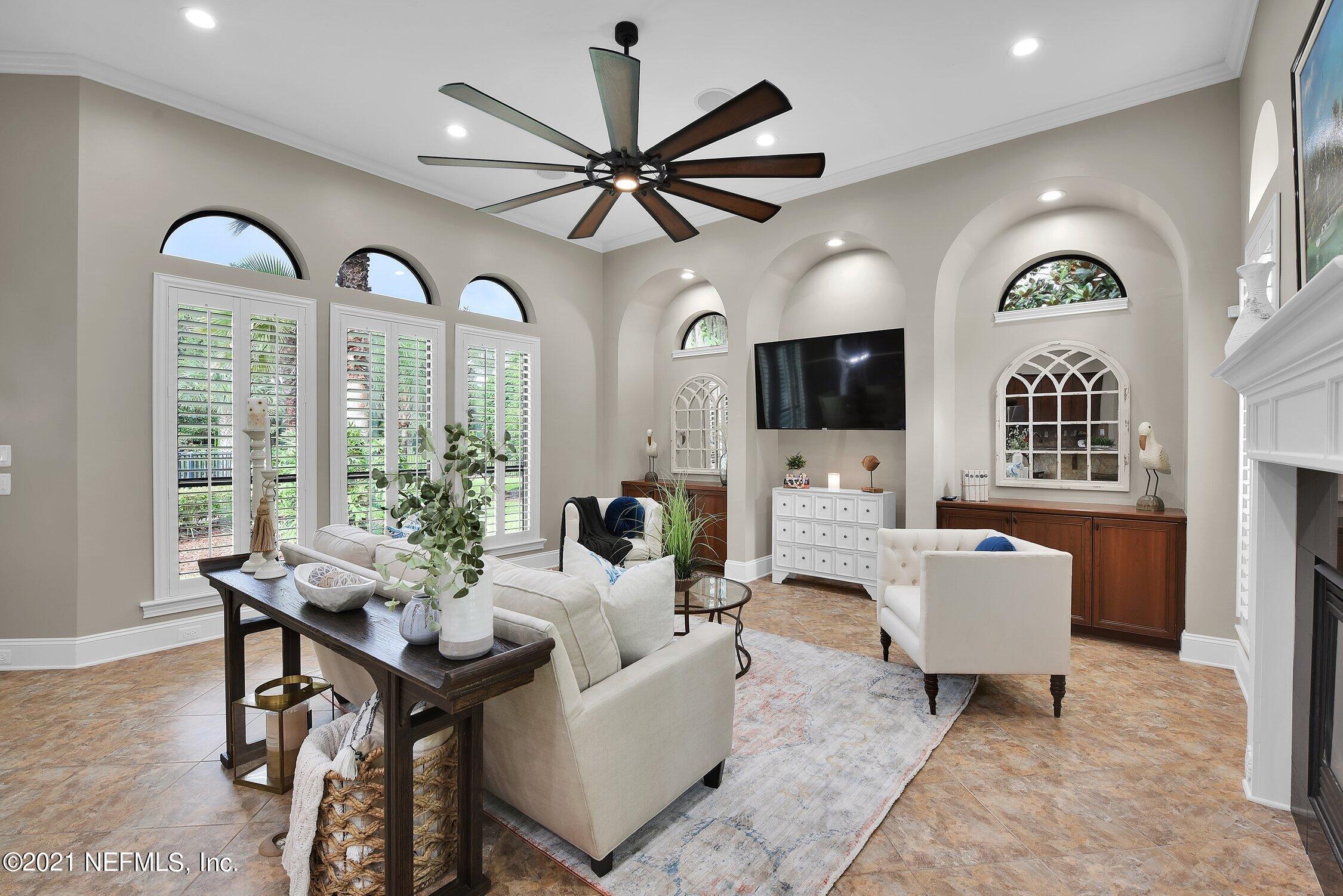 142 Marshall Creek Drive St. Augustine, FL 32095 - Photo 48 of 176 a living room with furniture chandelier and a flat screen tv