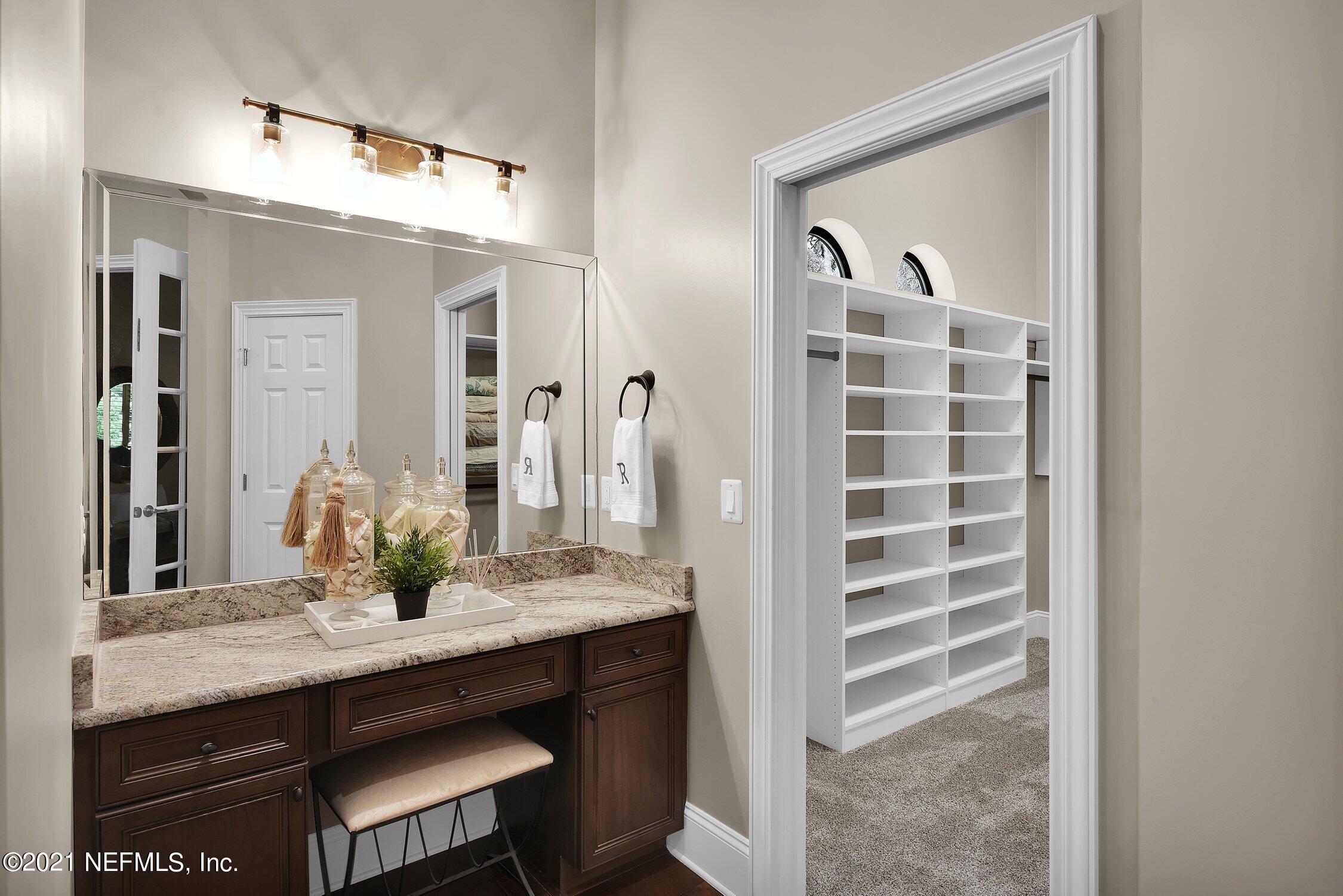 142 Marshall Creek Drive St. Augustine, FL 32095 - Photo 58 of 176 a bathroom with a granite countertop sink and a mirror