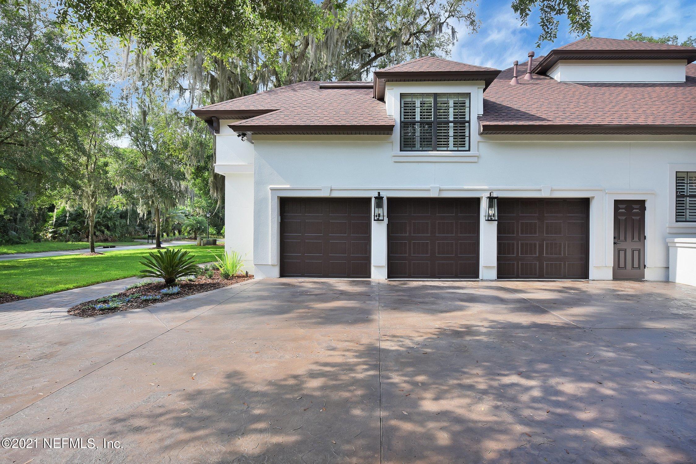 142 Marshall Creek Drive St. Augustine, FL 32095 - Photo 6 of 176 a front view of a house with a garden and garage