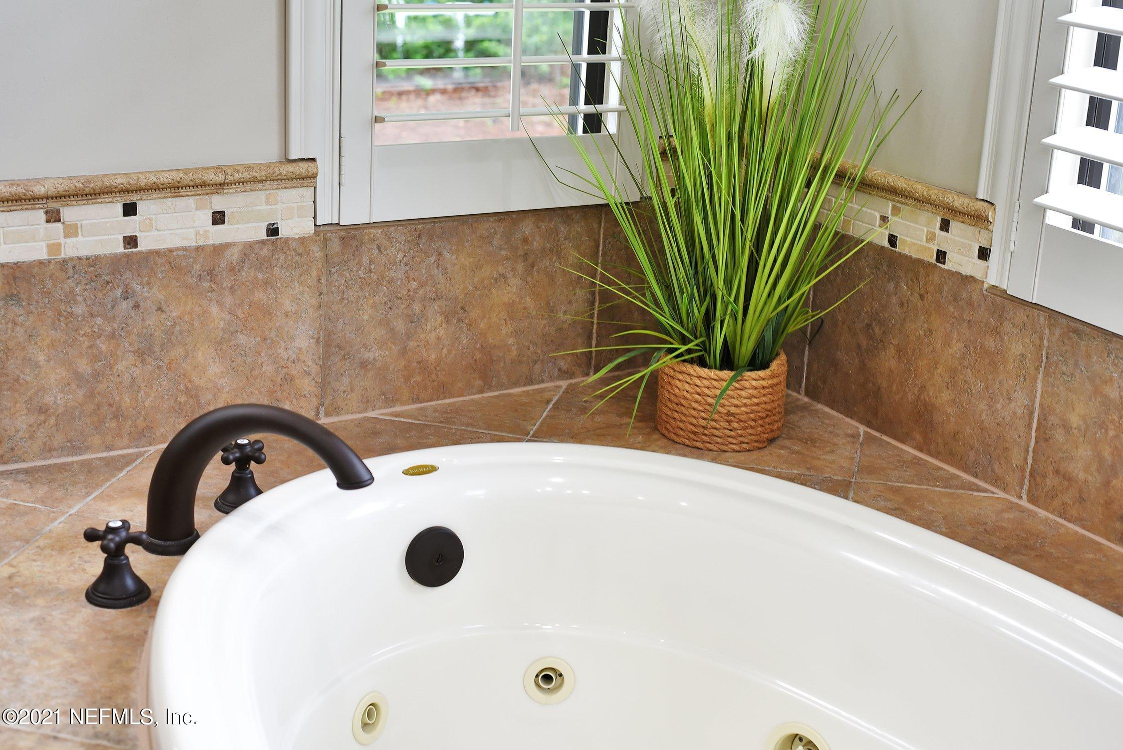 142 Marshall Creek Drive St. Augustine, FL 32095 - Photo 63 of 176 a bathroom with a sink a mirror and potted plant