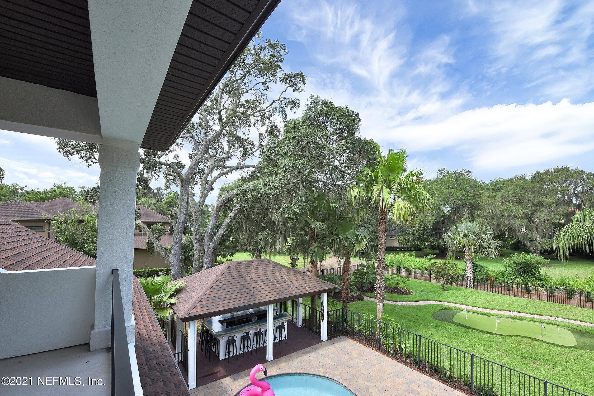 142 Marshall Creek Drive St. Augustine, FL 32095 - Photo 75 of 176 a view of a patio with a table chairs and a yard