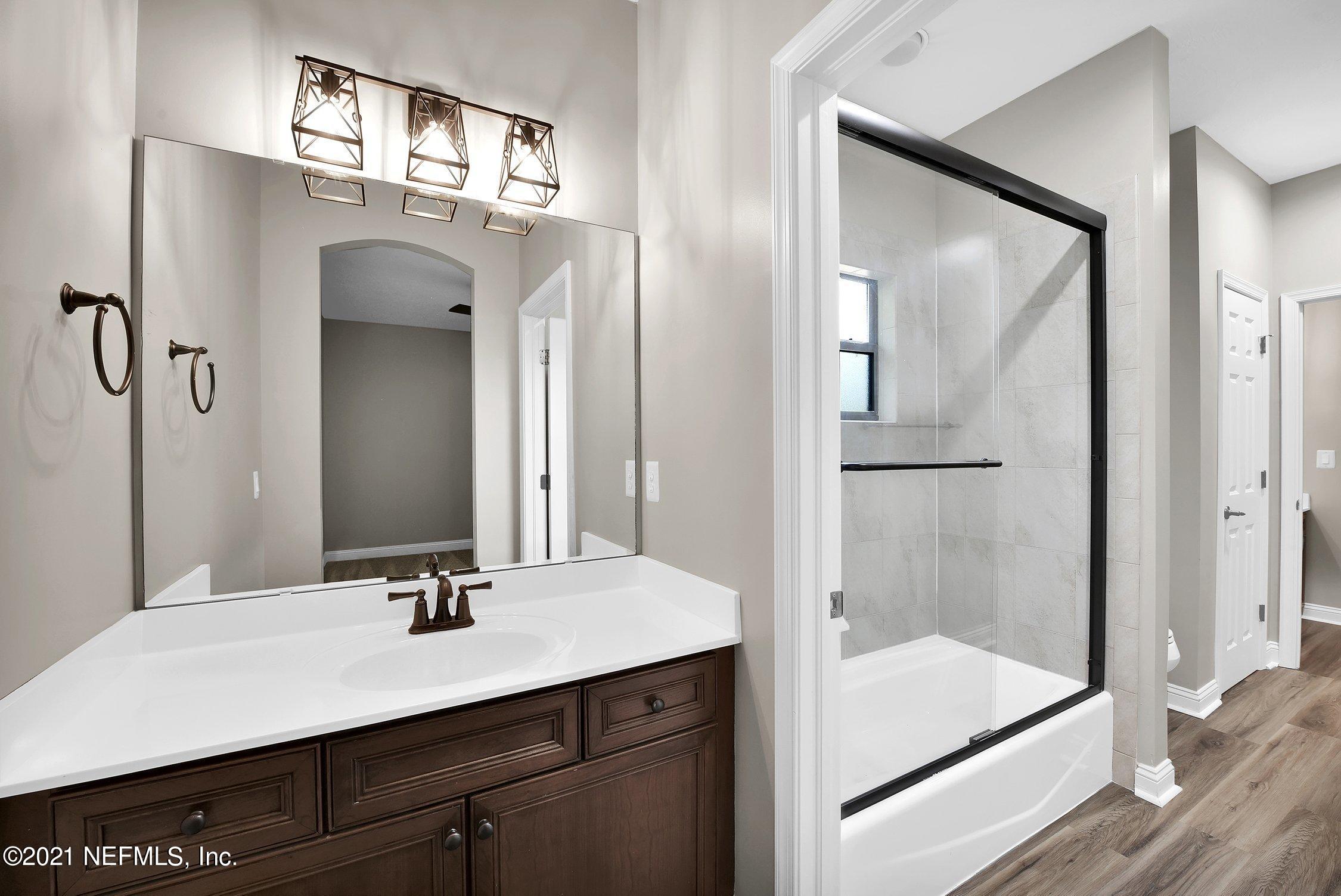 142 Marshall Creek Drive St. Augustine, FL 32095 - Photo 80 of 176 a bathroom with a sink a shower and a mirror