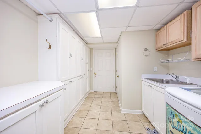 a view of a storage & utility room with a sink