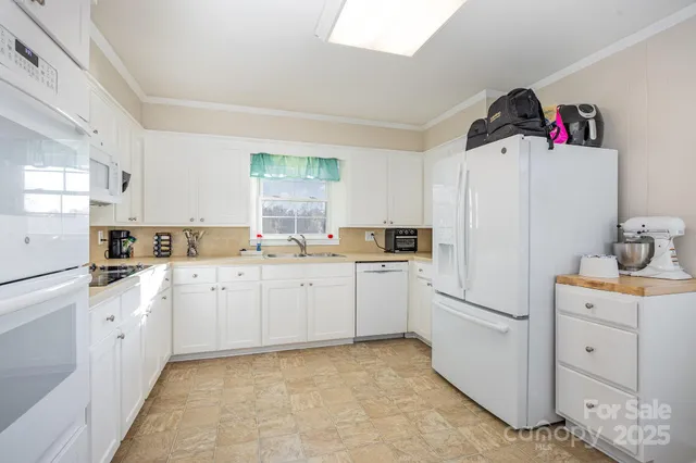 a kitchen with cabinets appliances and a window